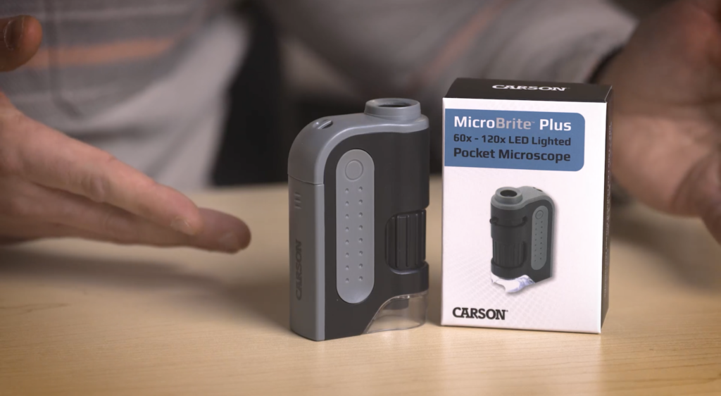 Carson MicroBrite pocket microscope, placed next to box. From Carson's Amazon page video