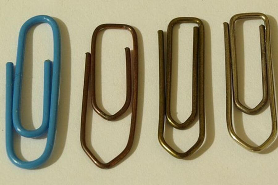 four paperclips lined up next to the other