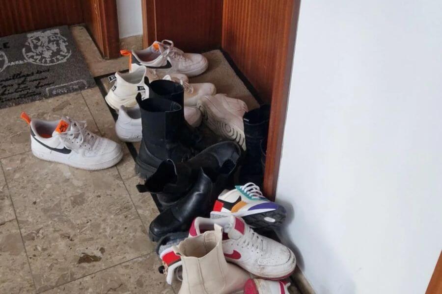 shoes piled up in a hallway