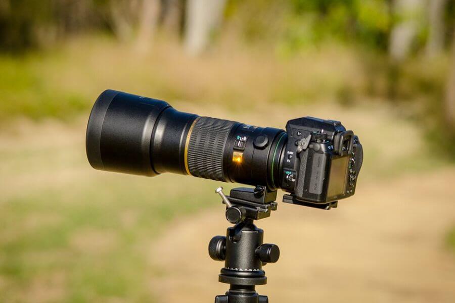 DSLR Camera with Lens on a Tripod head.