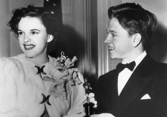 Mickey Rooney presenting a special Academy Award to Judy Garland, who was adjudged the outstanding juvenile actress of 1939 at the 12th Annual Award Dinner of the Academy Motion Picture Arts and Sciences.